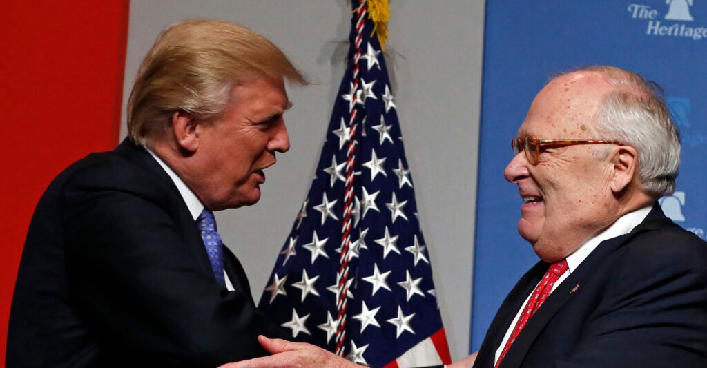 Heritage Foundation president and founder Ed Feulner (R) greets President Donald J. Trump.