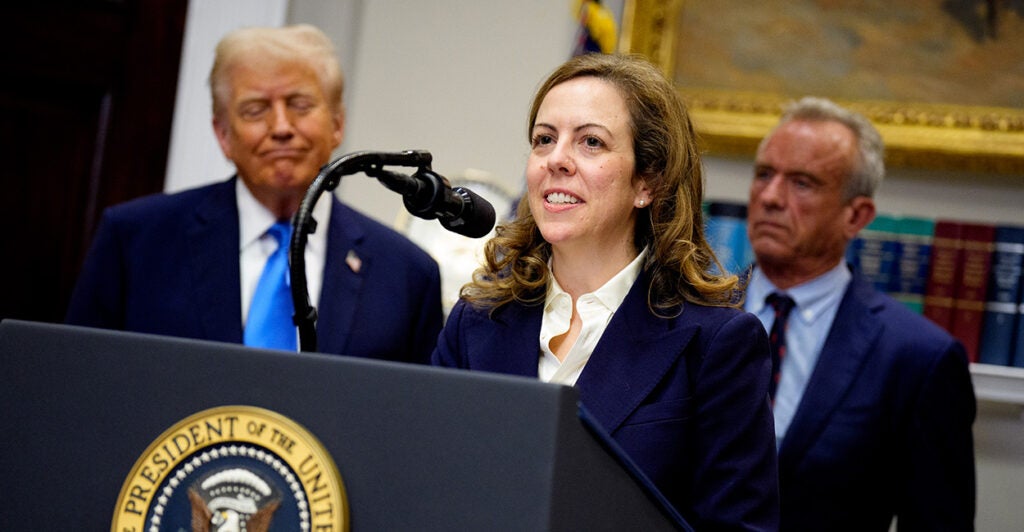 Dr. Dorothy Fink, acting assistant secretary for HHS and head of the Office of Women's Health, speaks to the media while standing at a podium with President Donald Trump and Department of Health and Human Services Secretary Robert Kennedy behind her
