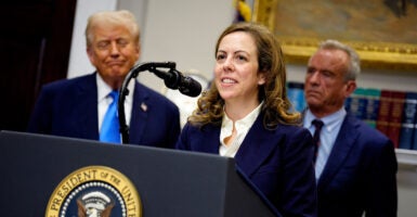 Dr. Dorothy Fink, acting assistant secretary for HHS and head of the Office of Women's Health, speaks to the media while standing at a podium with President Donald Trump and Department of Health and Human Services Secretary Robert Kennedy behind her