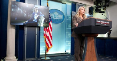 Presidential press secretary Karoline Leavitt behind a lectern in the White House press briefing room