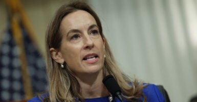 U.S. Rep. Mikie Sherrill with a US flag in the background