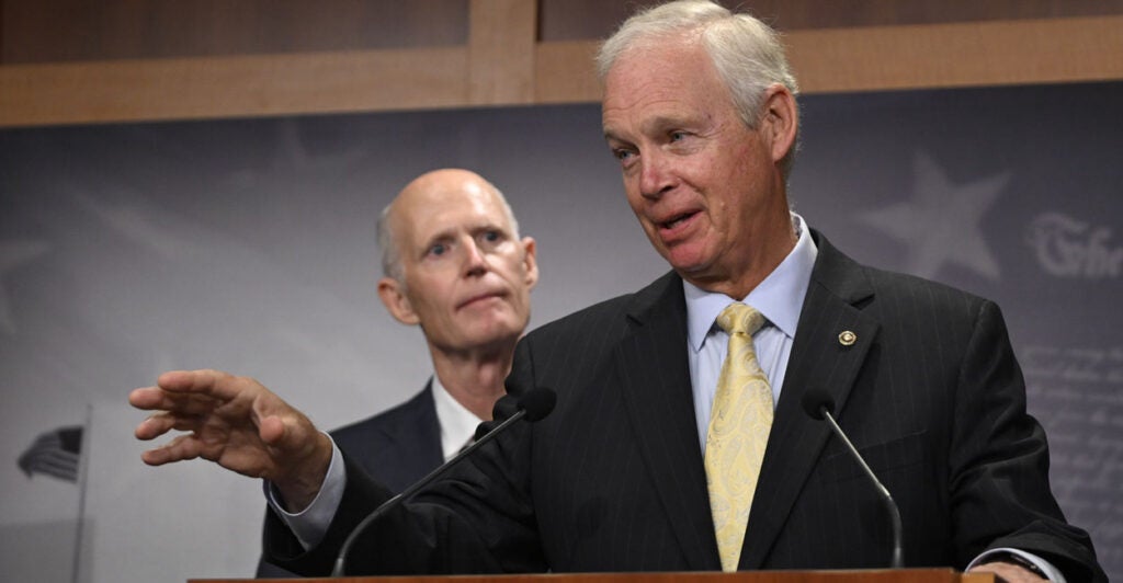 With Sen. Rick Scott, R-Fla., looking on, Sen. Ron Johnson, R-Wis., addresses a news conference in Washington on Sept. 11, 2024.