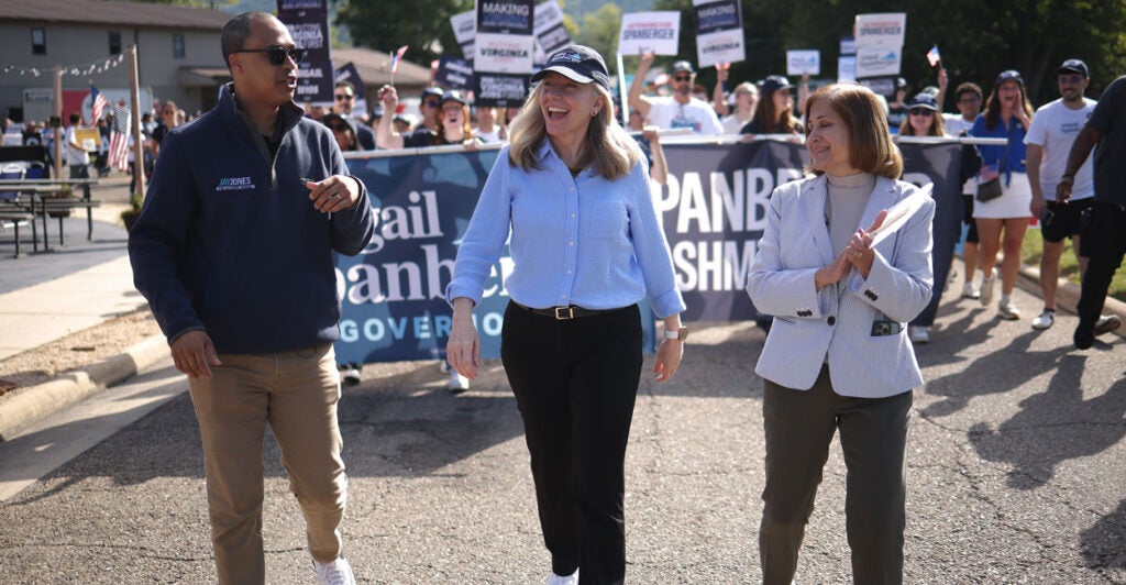Virginia Democratic gubernatorial candidate Abigail Spanberger (center) marches in the annual Labor Day festival parade with the Democrat nominee for lieutenant governor, state Sen. Ghazala Hashmi (right), and Democrat nominee for attorney general Jay Jones on Sept. 1 in Buena Vista, Va.