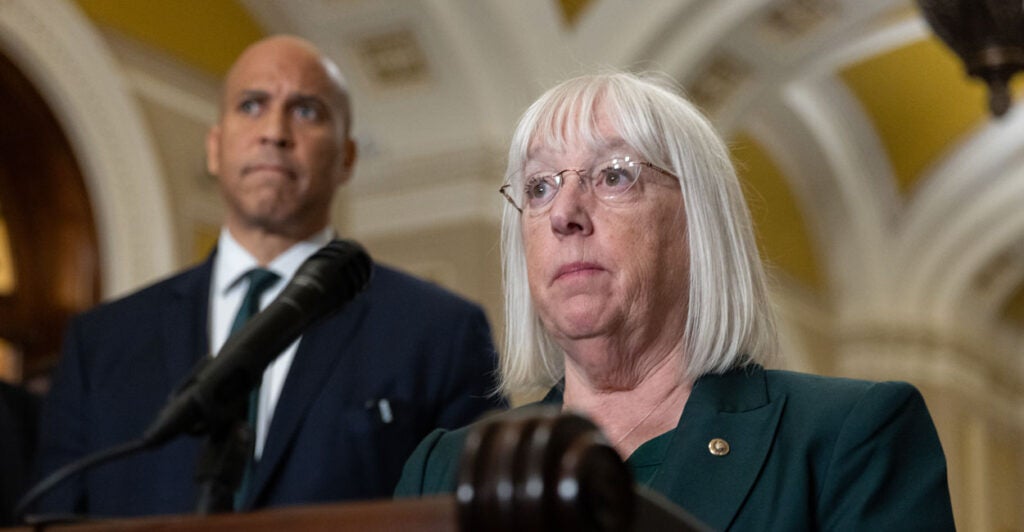 With Sen. Cory Booker, D-N.J., looking on, Sen. Patty Murray, D-Wash., speaks at a press conference at the Capitol on Oct. 15.