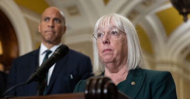 With Sen. Cory Booker, D-N.J., looking on, Sen. Patty Murray, D-Wash., speaks at a press conference at the Capitol on Oct. 15.