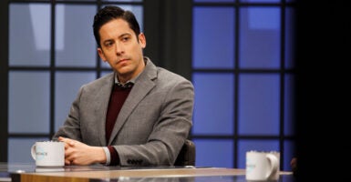 Conservative commentator Michael Knowles is seen here on Jan. 11, 2022, in Nashville, Tenn., seating behind a desk with a coffee mug in front of him.