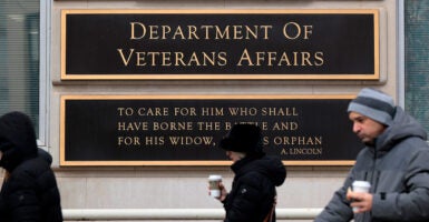 People walk past the Department of Veterans Affairs headquarters in Washington, D.C., on March 6.