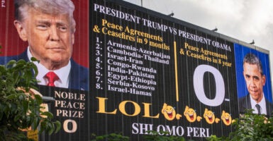 A billboard listing President Trump's many accomplishments compared to President Obama's zero accomplishments.