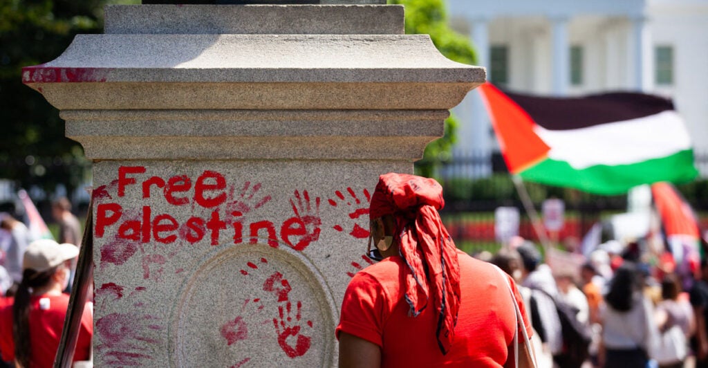 Mock bloody handprints sully a statue's pedestal in Lafayette Park in Washington as pro-Palestinian demonstrators protest on June 8, 2024.