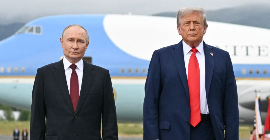 President Donald Trump and Russian President Vladimir Putin pose on the tarmac after arrival at Joint Base Elmendorf-Richardson in Anchorage, Alaska, on Aug. 15.