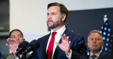 JD Vance speaks with his hands in front of him at a press conference.