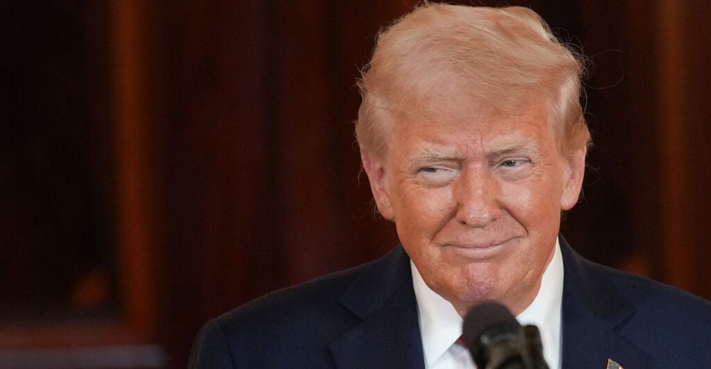 Close-up of President Donald Trump smiling, looking to his right