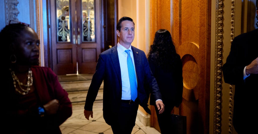 Sen. Bernie Moreno looks forward as he walks through the Senate.