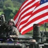 A U.S. soldier sits atop a Stryker infantry carrier vehicle crossing a river over a floating bridge during a joint U.S.-South Korea river-crossing drill as part of annual military exercises in Yeoju, South Korea, on Aug. 27.