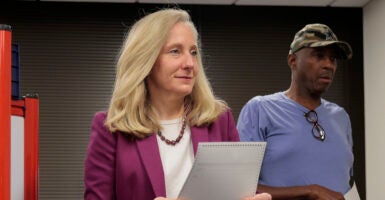 Abigail Spanberger in purple holds a ballot.