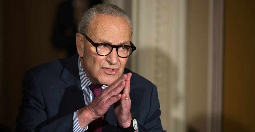 Senate Minority Leader Chuck Schumer, D-N.Y., presses his hands together at a Capitol news conference on the federal government shutdown.