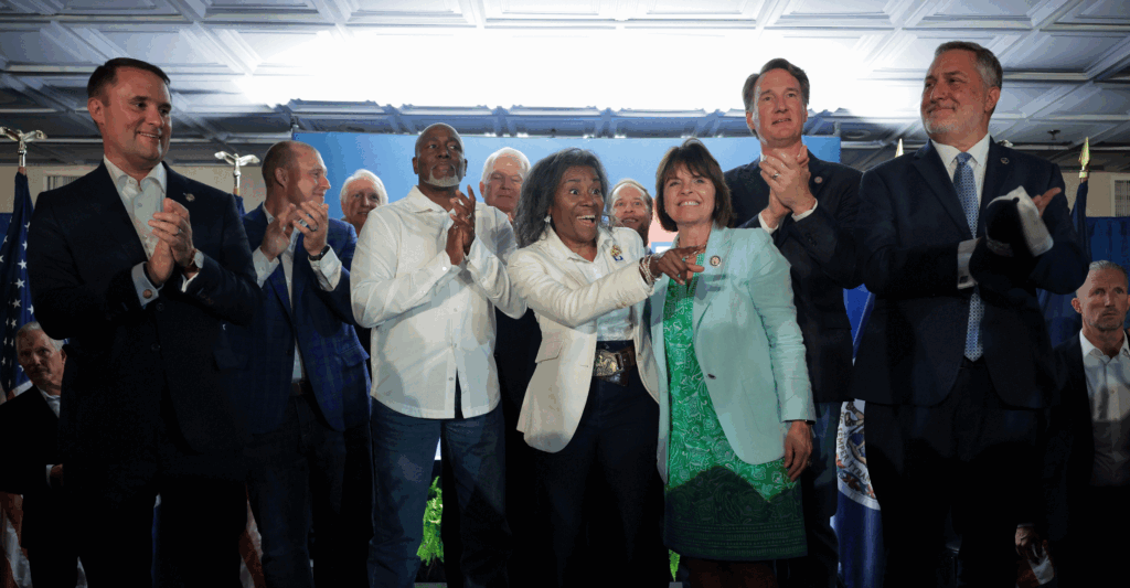 Virginia Republican candidates—Jason Miyares (left), Winsome Earle-Sears (center), and John Reid (right), along with Gov. Glenn Youngkin (second from right)—gather before supporters at a campaign event on July 1 in Vienna, Va. (Kayla Bartkowski/Getty Images)
