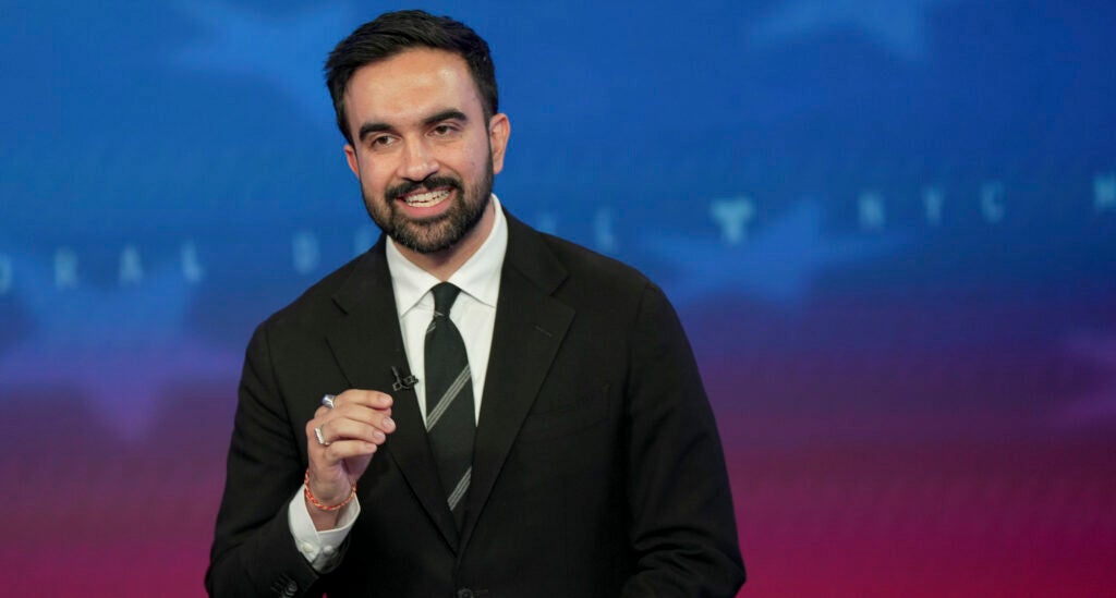 Democratic mayoral nominee Zohran Mamdani speaks during a mayoral debate at Rockefeller Center, looking directly at the camera.