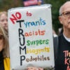 A crowd of mainly American anti Trump protestors holds signs outside the US Embassy London during a "No Kings" protest against U.S. President Donald Trump.