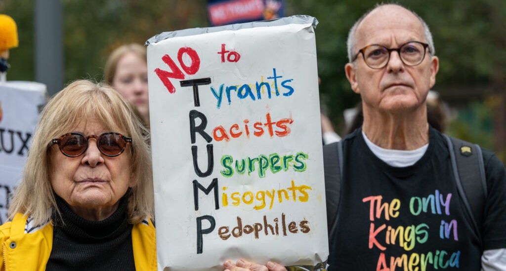 A crowd of mainly American anti Trump protestors holds signs outside the US Embassy London during a "No Kings" protest against U.S. President Donald Trump.