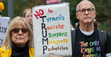 A crowd of mainly American anti Trump protestors holds signs outside the US Embassy London during a "No Kings" protest against U.S. President Donald Trump.