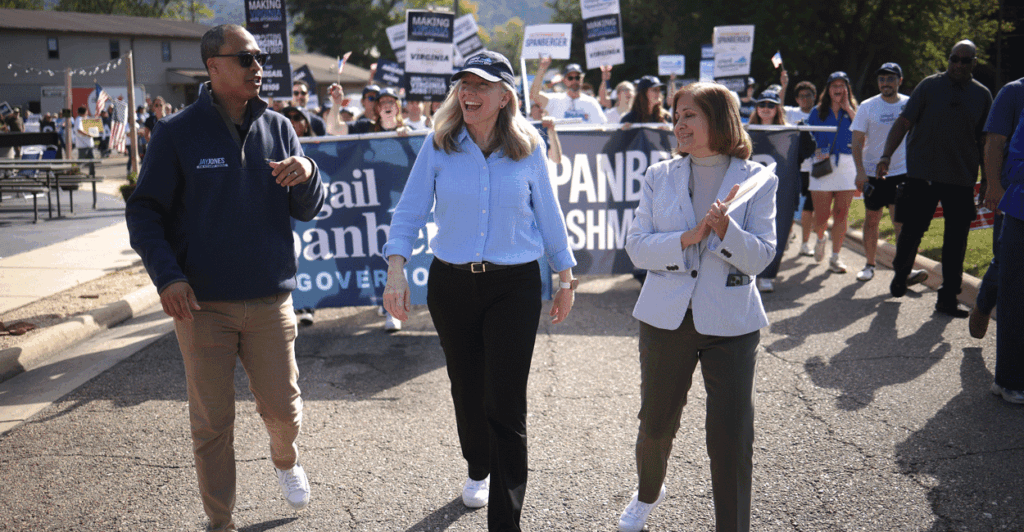 Three Virginia statewide candidates Jay Jones, Abigail Spanberger, and Ghazala Hashmi walk in a parade.
