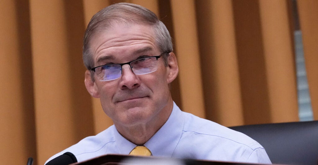 House Judiciary Chairman Jim Jordan sits at the dais as he glances up during a hearing.