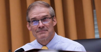 House Judiciary Chairman Jim Jordan sits at the dais as he glances up during a hearing.