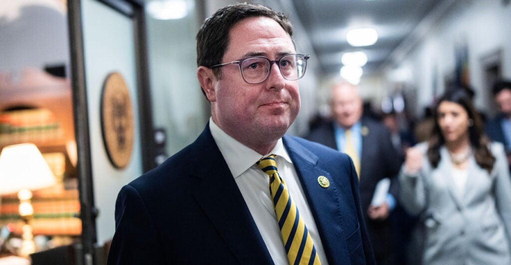 Rep. Mike Flood stands in a capitol hallway.