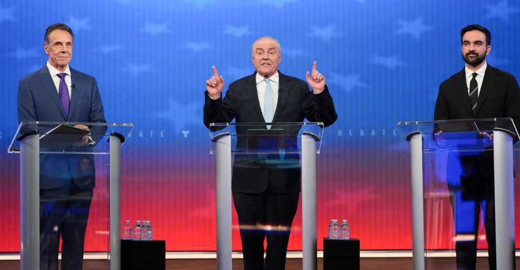 Republican nominee Curtis Sliwa (C) speaks alongside Independent nominee former, New York Gov. Andrew Cuomo (L) and Democratic nominee Zohran Mamdani during a mayoral debate.