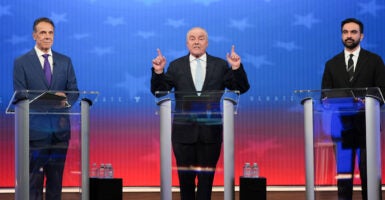 Republican nominee Curtis Sliwa (C) speaks alongside Independent nominee former, New York Gov. Andrew Cuomo (L) and Democratic nominee Zohran Mamdani during a mayoral debate.