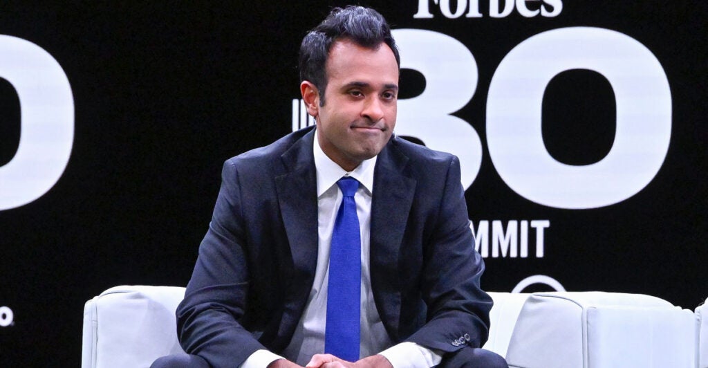Vivek Ramaswamy sits on a stage for a Forbes event.