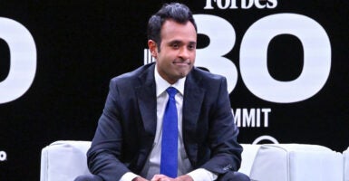 Vivek Ramaswamy sits on a stage for a Forbes event.