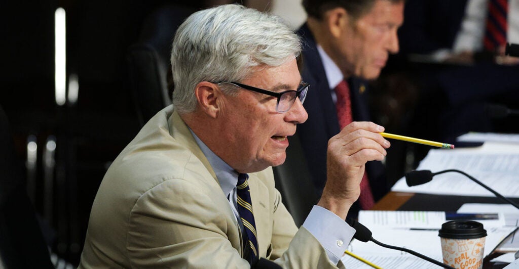 Sheldon Whitehouse in a tan suit points a pencil at someone. Whitehouse sent a letter to Heritage demanding documents in what Kevin Roberts says is an attempt to "silence" critics of climate alarmism.