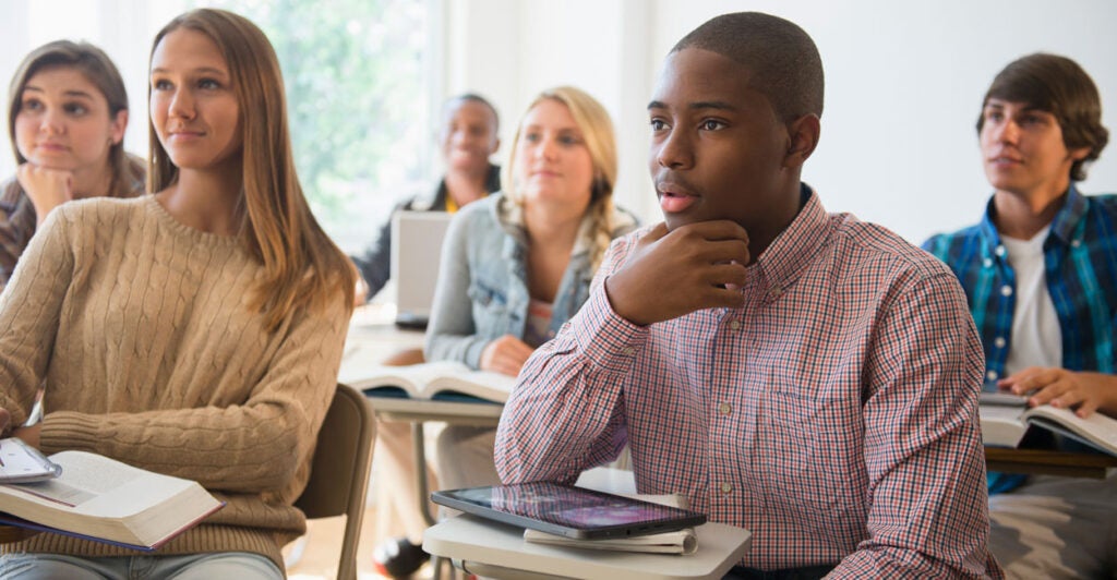 Teenage students listening in classroom