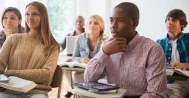 Teenage students listening in classroom