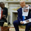 Donald Trump showing an article while seated with South African president Cyril Ramaphosa.