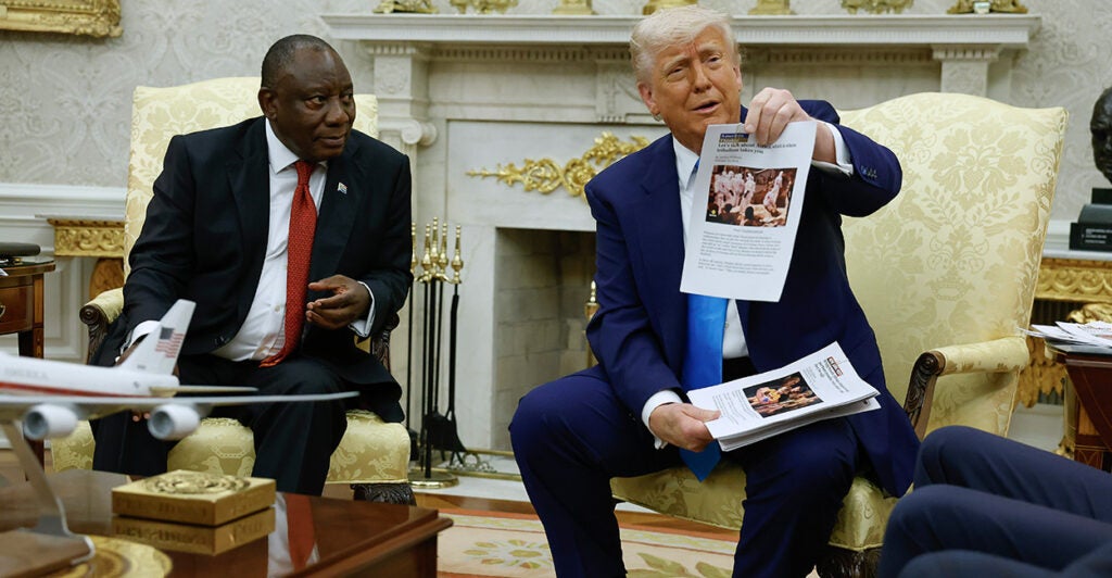 Donald Trump showing an article while seated with South African president Cyril Ramaphosa.