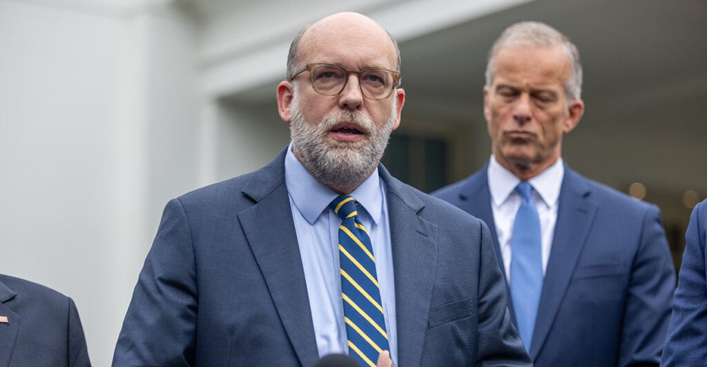 OMB Director Russ Vought speaks to reporters outside the White House.