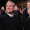 Chief Justice John Roberts and Justce Brett Kavanaugh clap in robes