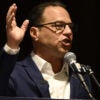 Democrat Pennsylvania Gov. Josh Shapiro at a microphone and gesturing with his right arm
