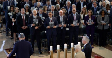 From left: Then-President Joe Biden; House Speaker Mike Johnson and House Majority Leader Steve Scalise, both R-La.; and House Minority Leader Hakeem Jeffries, D-N.Y., hold photos of victims of the Holocaust during the U.S. Holocaust Memorial Museum's annual Days of Remembrance ceremony at the Capitol on May 7, 2024.
