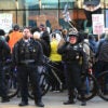 Demonstrators hold up signs as they are surrounded by police during a protest in Chicago.