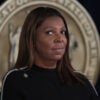 Letitia James, in a black sweater looks side-eyed at the camera.