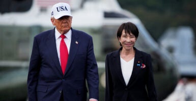 Donald Trump walks with Japanese Prime Minister Sanae Takaichi.