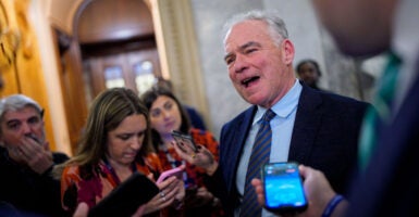 Sen. Tim Kaine talks to reporters on Capital Hill.