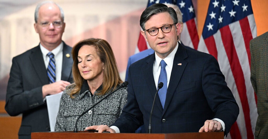 Speaker Mike Johnson at a podium, speaking to reporters.