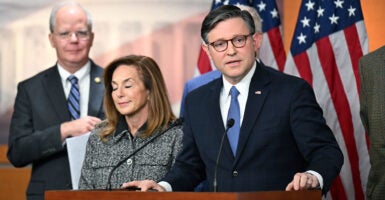 Speaker Mike Johnson at a podium, speaking to reporters.