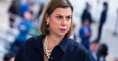 Close-up of Elissa Slotkin in a blue blouse with large white pear necklace.