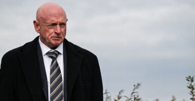 Sen. Mark Kelly, D-Ariz., in black coat.